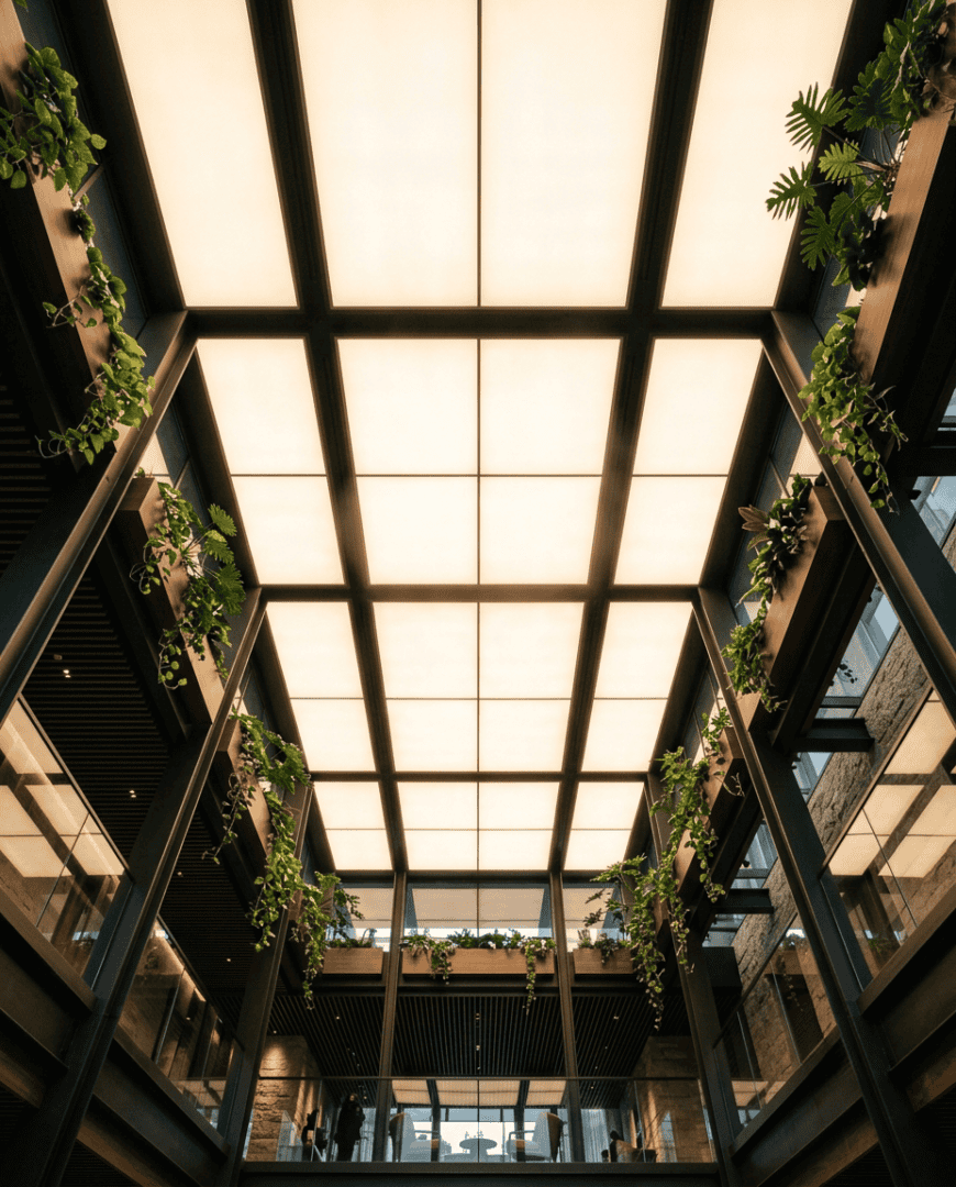 SOL Series Cloud backlit ceiling panels illuminating a modern building atrium with warm even light